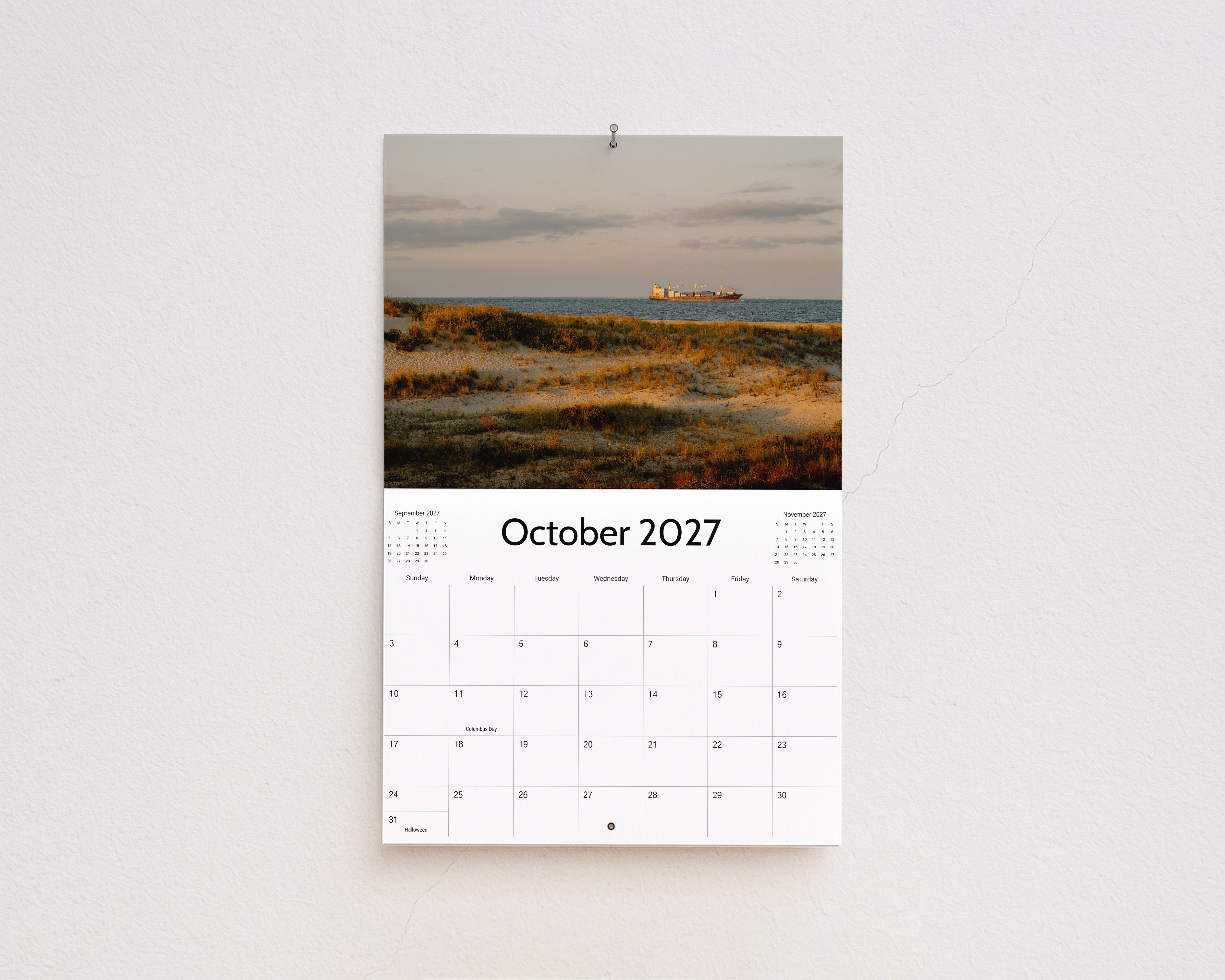 October 2027 page: golden dune grass with a cargo ship on the horizon