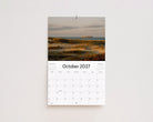 October 2027 page: golden dune grass with a cargo ship on the horizon