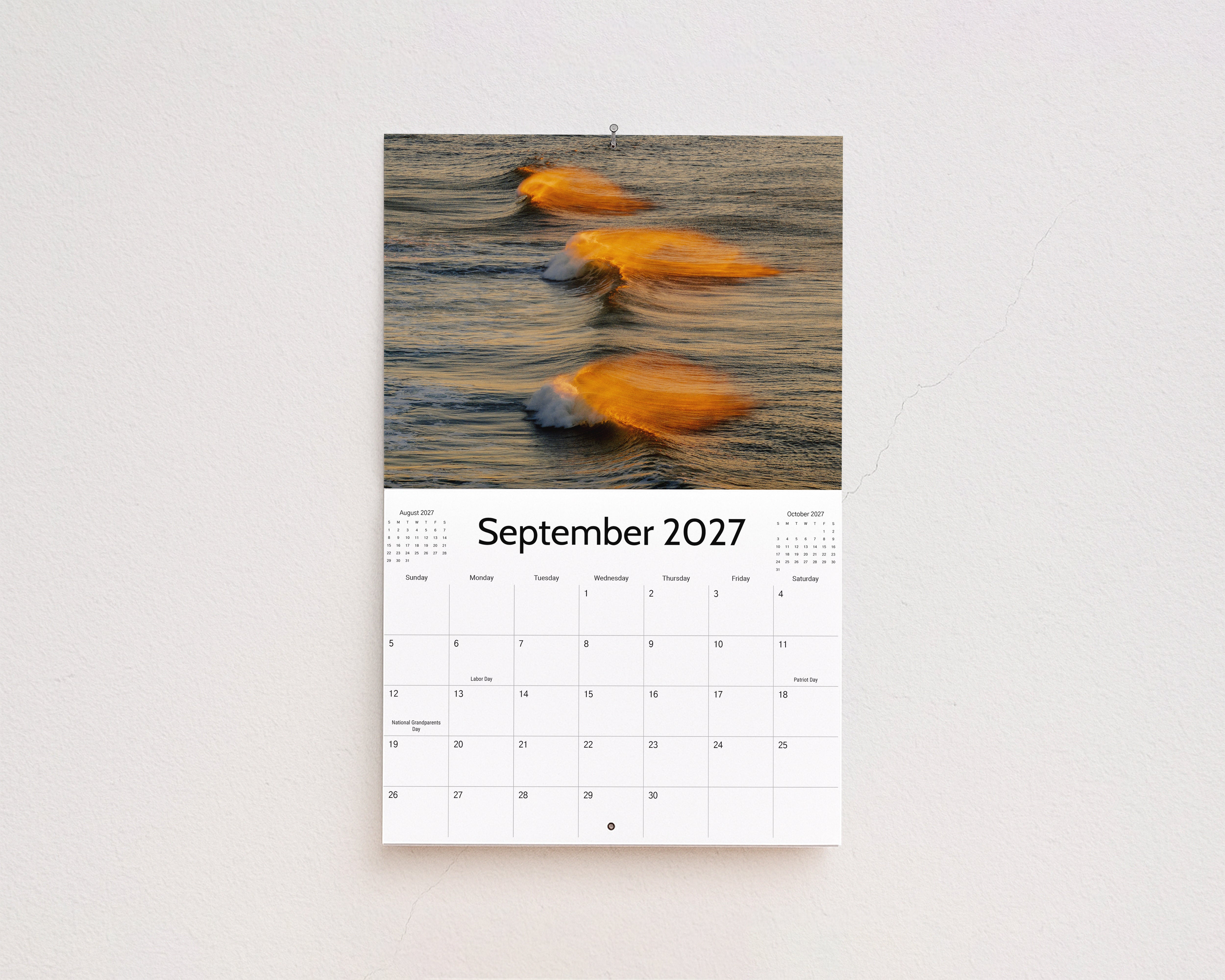 September 2027 page: three small waves glowing gold in the morning light