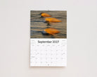 September 2027 page: three small waves glowing gold in the morning light